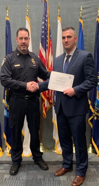 Captain Marron congratulates Det. Sgt. Palmieri